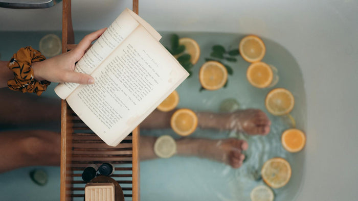 Person in the bathtub reading a book