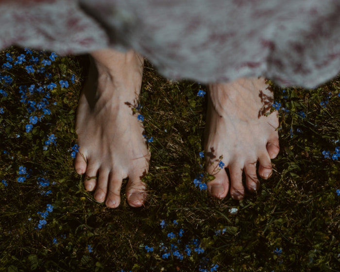 Feet in grassy field