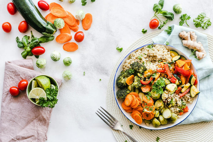 Bowl of salad and vegetables on counter