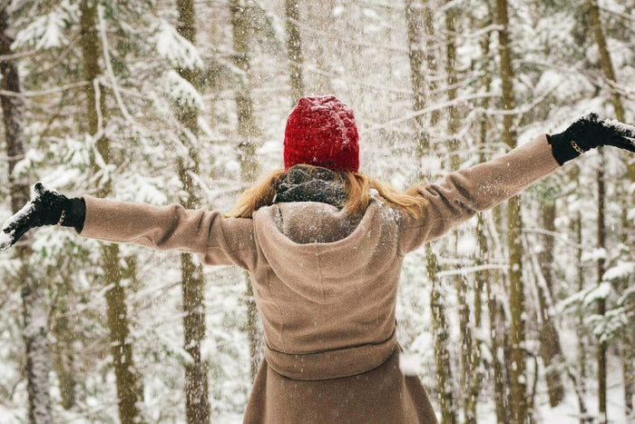 A woman outdoors in snow benefits from the best socks warmth